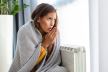 glavna-stockphotounwellwomanrenterinblanketsitincoldlivingroomhandonoldradiatorsufferfromlackof2194563235.jpg
