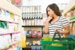 confusedfemalecustomerchoosingfoodproductsshelfsupermarket.jpg