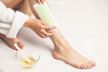 stock-photo-woman-uses-wax-tape-to-remove-hair-on-legs-1748471486.jpg