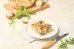 stock-photo-sliced-zucchini-casserole-with-mushrooms-chicken-and-cheese-on-a-plate-on-a-light-concrete-2500640527.jpg