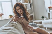 test-stockphotofinallypregnantattractiveyoungwomenlookingatpregnancytestandsmilingwhilesittingonthe1074118598.jpg