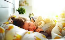 stockphotochildgirlsleepsinherbedwithatoyteddybearinmorning1022465197.jpg