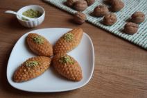 stockphotothereareturkishdessertskalburabastonawhiteplateonawoodentablewalnutsandchunks2339452611.jpg