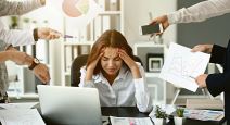stockphotostressedbusinesswomanwithalotofworksittingatworkplaceinofficetimemanagementconcept2242789169.jpg