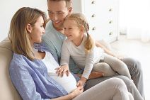 stockphotoyoungpregnantwomanwithherfamilyathome1077329474.jpg