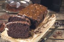 stockphotomoistchocolatecakewithmilkchocolatetoppingglazeandcocoapowder558350308.jpg