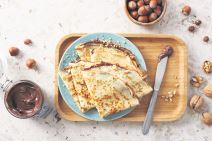 stock-photo-homemade-crepes-tasty-thin-pancakes-with-chocolate-and-nuts-1489930856.jpg