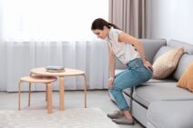 NEUDOBAN KAUC   stock-photo-young-woman-suffering-from-hemorrhoid-on-sofa-at-home-1637957935.jpg