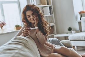 test-stockphotofinallypregnantattractiveyoungwomenlookingatpregnancytestandsmilingwhilesittingonthe1074118598.jpg
