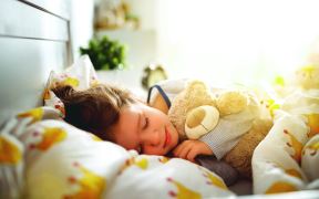 stockphotochildgirlsleepsinherbedwithatoyteddybearinmorning1022465197.jpg