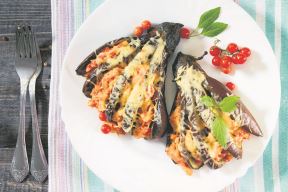 stockphotobakedeggplantwithcheesetomatoesandchickenonadarkwoodentabletopview315288311.jpg