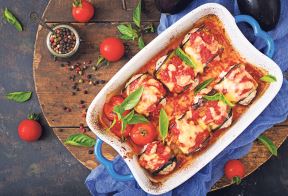 stockphotoeggplantauberginerollswithmeatintomatosauceflatlaytopview709414288.jpg