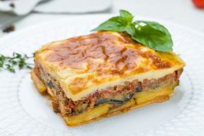 stock-photo-eggplant-moussaka-greek-cuisine-on-white-plate-on-white-concrete-table-1937801719.jpg