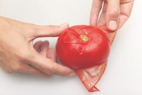 stock-photo-hands-are-removing-the-peel-from-red-tomato-597419105.jpg