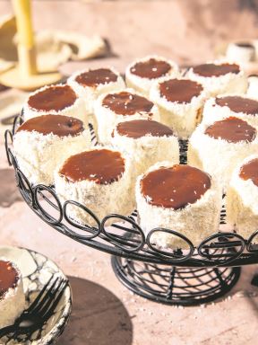stock-photo-russian-hats-famous-balkan-dessert-with-chocolate-frosting-and-cocoa-flakes-served-on-a-round-2550899613.jpg