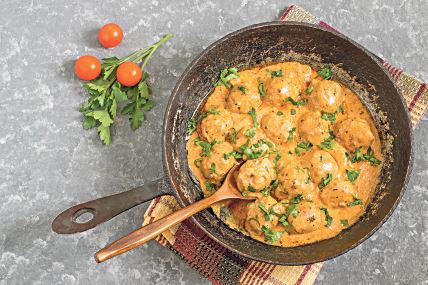 stockphototastyhomemademeatballsstewedincreamytomatosauceinoldcastironfryingpanfryingpanwith1017064132.jpg