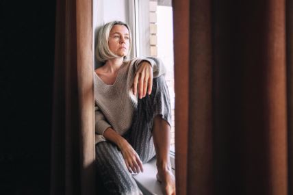 stockphotosadadultwomanlookinwindowdistancethinkingorponderingaloneathomethoughtfulupset2193124113.jpg