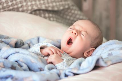 stockphotocutebabyyawningbeforesleep550642420.jpg