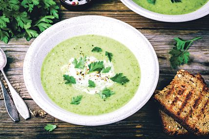 stockphotobowlofgreenzucchinicreamsoupwithfreshparsleyonwoodenbackground707924710.jpg