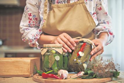 stockphotocloseupofhomemadepickledcannedcucumbersandchilipeppersinsterilizedglassjarsinthe2189245817.jpg