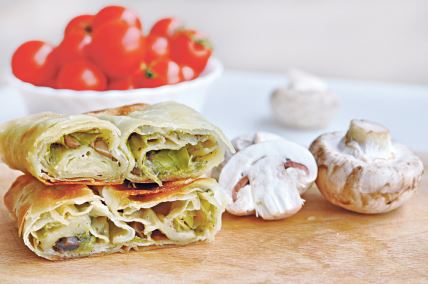 stockphotohomemademushroomspiefreshpieceofsavorystrudelstuffedwithleekandmushroomsservedona1782169403.jpg