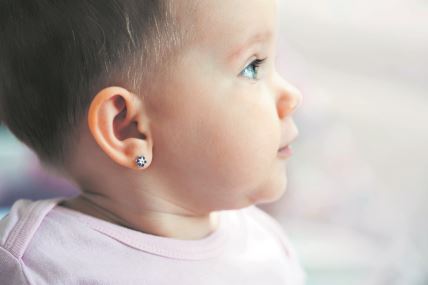 stockphotolovelybabyfacepiercedearsstarflowerearringsblueeyes770258158.jpg