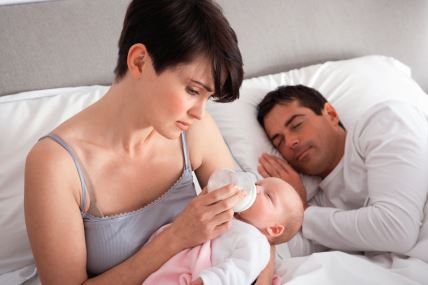 stockphotomotherfeedingnewbornbabyinbedathome74652766.jpg