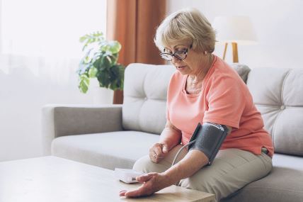 stockphotoseniorwomanwithhypertensionmeasuringbloodpressureherselfathomesadmatureladymeasure2333257471.jpg