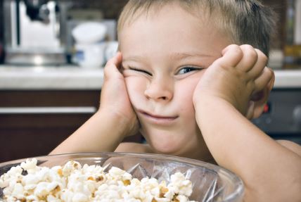 stockphotobabyboyisposingafacenearthebowlofpopcornonakitchenequipmentbackground313631642.jpg