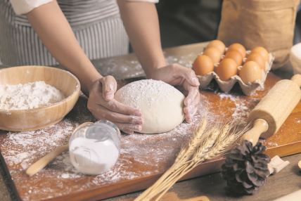 stockphotowomanhandsprepareandrestthedoughbeforeputtingthedoughintotheoven2247277587.jpg