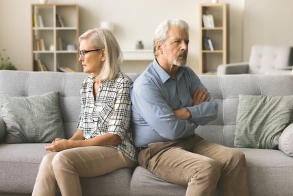 stockphotoannoyedignoringseniorcouplesittingonhomecouchbacktobacklookingawaykeepingsilence2349818671.jpg