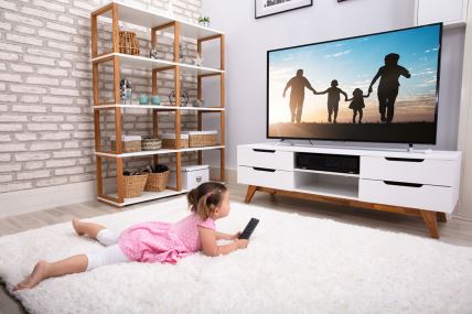 stockphotorearviewofinnocentgirllyingoncarpetwatchingtelevision1369035104.jpg