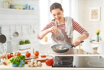 stock-photo-healthy-food-at-home-happy-woman-is-preparing-the-proper-meal-in-the-kitchen-1397470610.jpg