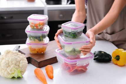 GLAVNA  stock-photo-woman-holding-stack-of-plastic-containers-with-fresh-vegetables-for-freezing-at-table-in-kitchen-1206769408.jpg