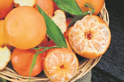 stock-photo-clementine-on-black-wooden-table-770412439.jpg