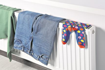stock-photo-clothes-hanging-on-white-radiator-in-room-2214251577.jpg