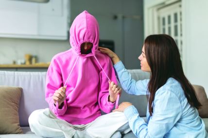 stock-photo-stubborn-upset-teenage-girl-putting-hood-on-head-and-avoiding-her-mom-apology-ignoring-talk-with-2486927965.jpg