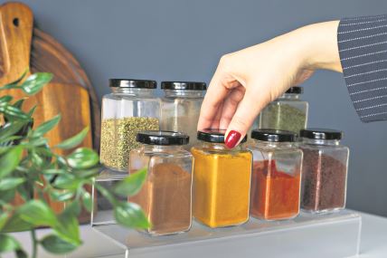 GLAVNA   stock-photo-cropped-hand-holding-jar-of-spices-on-kitchen-2428924671.jpg