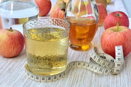 stock-photo-apple-cider-vinegar-diluted-with-water-measuring-tape-slimming-concept-1151133332.jpg