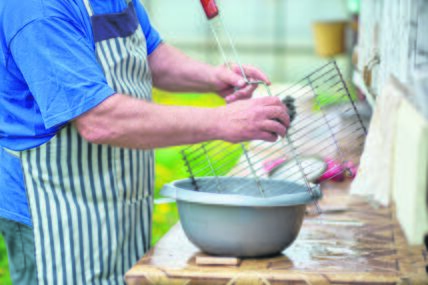 stock-photo-a-man-washes-the-grill-grate-with-a-soft-sponge-preparation-of-the-grill-for-frying-meat-2162420691.jpg