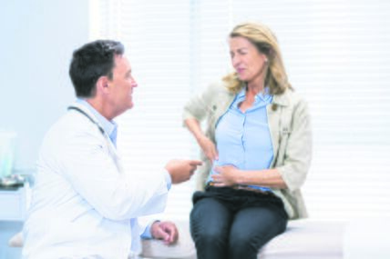 stock-photo-patient-suffering-from-stomach-ache-while-consulting-doctor-in-clinic-healthcare-workers-in-the-1176009247.jpg