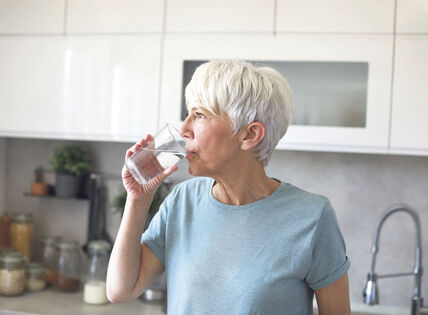 GLAVNA   stock-photo-portrait-of-a-happy-senior-mature-mid-aged-woman-holding-a-glass-and-drinking-water-and-having-a-2476189119.jpg
