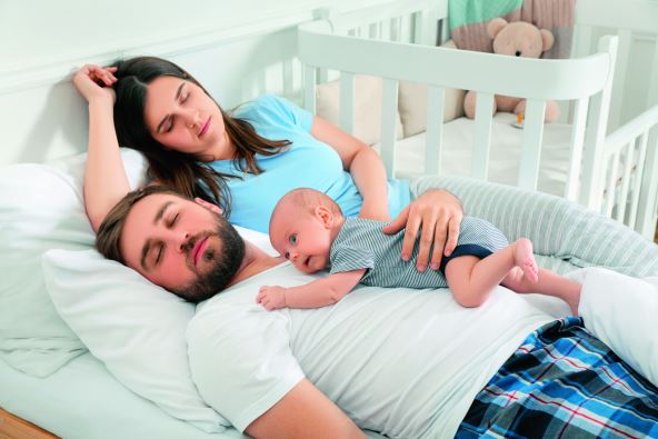 stockphototiredyoungparentswiththeirbabysleepinginbedathome2027545808.jpg