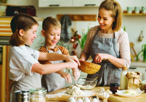stockphotocontentlovingmotherandcutekidssonanddaughteraddingingredientsinbowlandpreparing2154847315.jpg