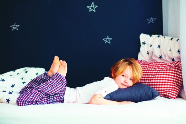 stockphotocutekidinpajamaslyinginbed554383462.jpg