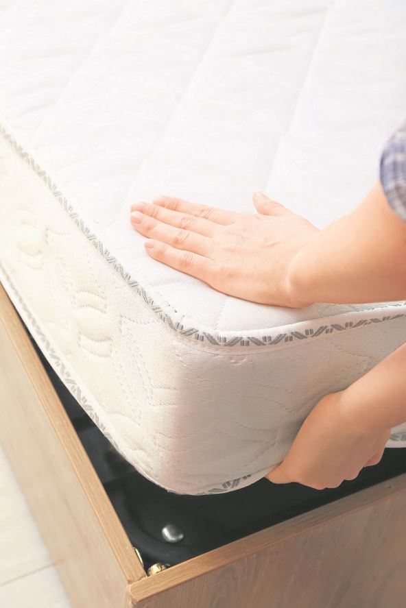 dusek-stockphotowomanputtingsoftorthopedicmattressonbedcloseup2038716452.jpg