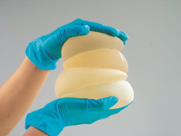 stockphototheplasticsurgeonholdsbreastsiliconeimplants2196978631.jpg