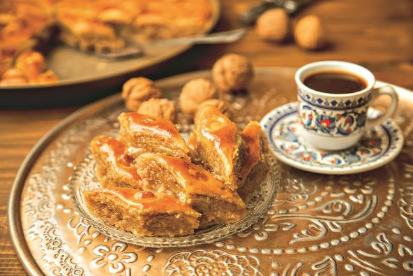 stockphotobaklavawithnutsonawoodenbackgroundselectivefocusfoodanddrink2127487700.jpg