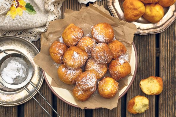 stockphotohomemadedeepfriedsweetricottafritterswithpowderedsugar1432966238.jpg