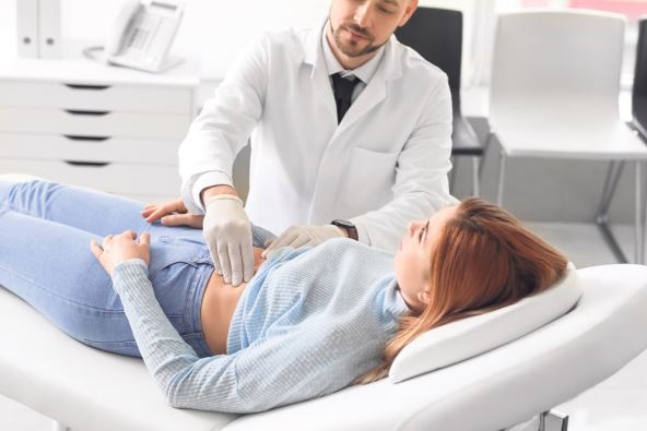 stockphotogastroenterologistexaminingwomaninclinic1978909748.jpg